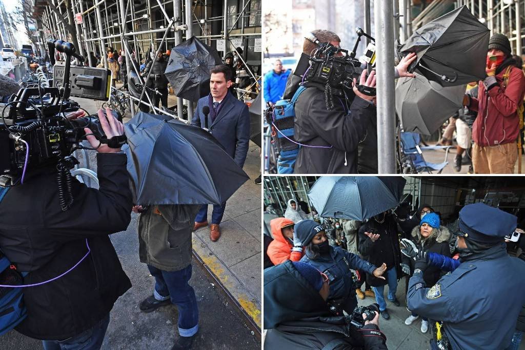 Article image for Migrant standoff in NYC turns ugly as 10 outside activists move against media with open umbrellas